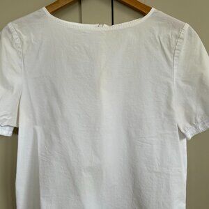 Samuji white cotton zip-up top with sleeve detail.